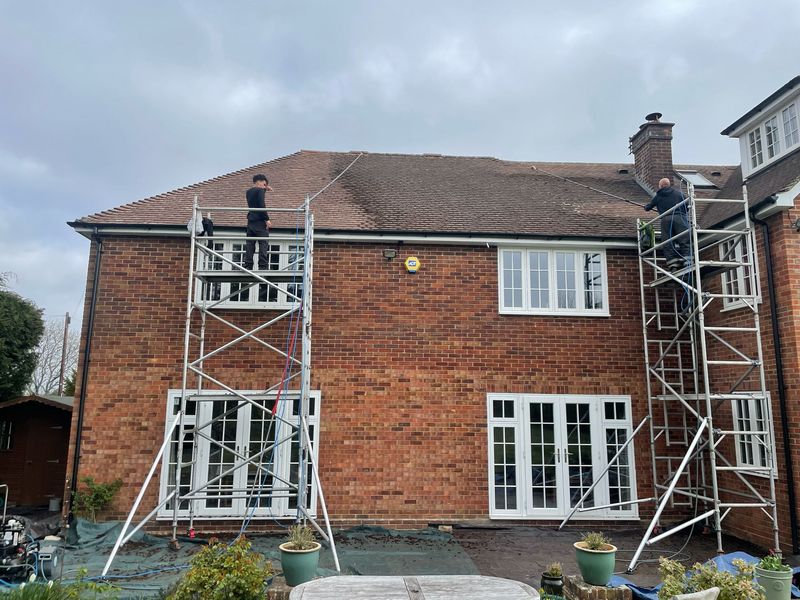 Roof cleaning carried out safely from scaffold towers by The Roof Moss Cleaners in Frimley